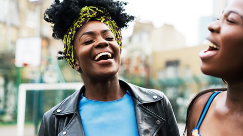 Two females laughing outside.