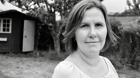 Dr Emma Kell is stood to the right, pictured outside in a field.