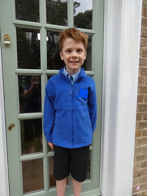 Rowan, a boy with autism and ADHD, standing in doorway on first day at special school after transition from home education.