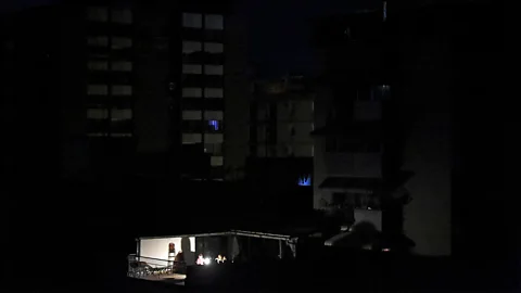 Getty Images The blackouts in Venezuela hit people's homes, causing pumps powering running water to stop and food to spoil in fridges. (Credit: Getty Images)
