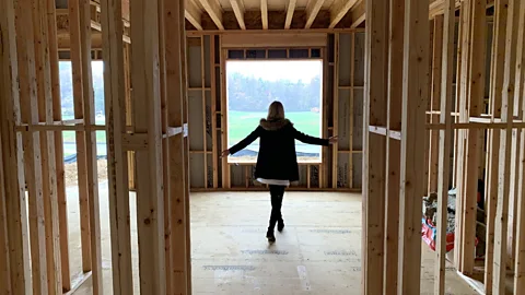 Rumson giving a tour of the construction so far in her new home (Credit: BBC)