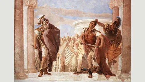 Alamy Enraged by the loss of his beloved, Achilles draws his sword to kill Agamemnon – but is stopped by the goddess Minerva, who holds him back by his hair (Credit: Alamy)