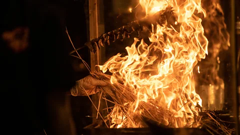 Jamie Lafferty The chef has to simultaneously keep the fire at its most furious and turn the fish to ensure an even sear (credit: Jamie Lafferty)