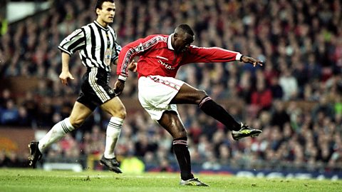 Andy Cole striking a football at Old Trafford.