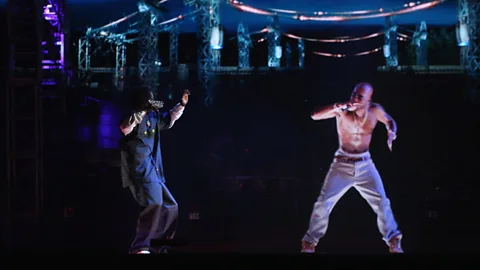 Getty Images A hologram of deceased rapper Tupac Shakur "performed" with living rapper Snoop Dogg in 2012 (Credit: Getty Images)