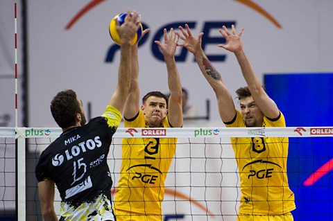 Photo of two Polish volleyball players blocking a shot during a game