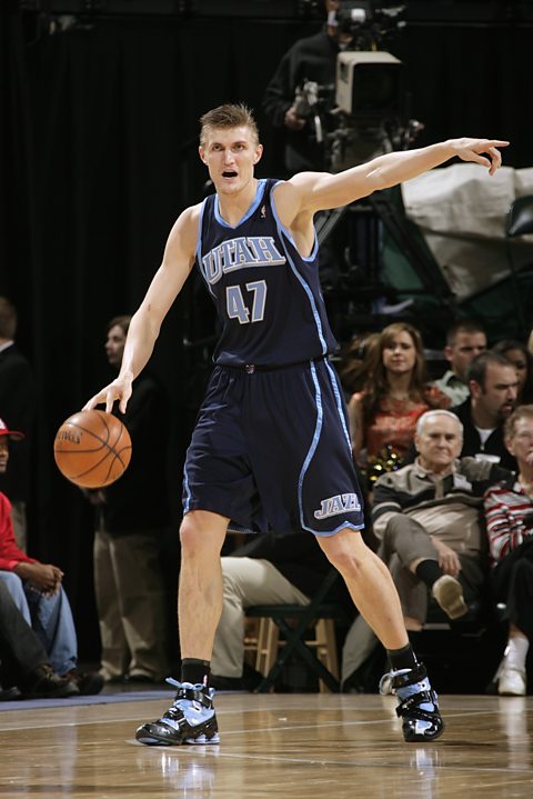 Andrei Kirilenko of the Utah Jazz points directing the offense as he handles the ball during the game