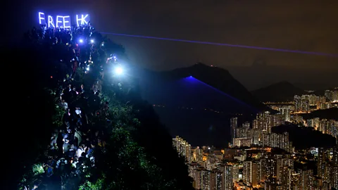 Getty Images Activists formed a human chain and held up LED letters that read ‘Free HK’ in a protest on Hong Kong’s Lion Rock (Credit: Getty Images)