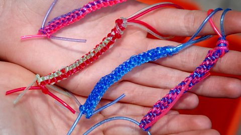 Four scoubidou braids of varying colours.