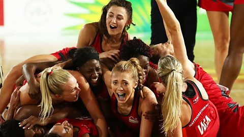 Several girls celebrating and lying down.