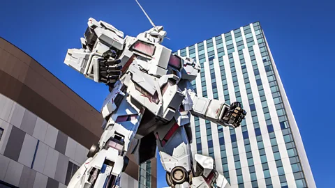 Prisma by Dukas/Getty Images A giant Gundam robot towers over passers-by in the Odaiba district of Tokyo (credit: Prisma by Dukas/Getty Images)