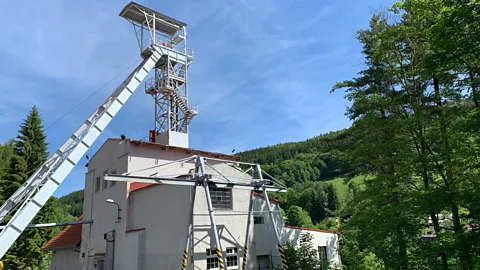 Eliot Stein The hulking Svornost mine shaft, the oldest continuously operated mine in Europe, still looms over Jáchymov (Credit: Eliot Stein)