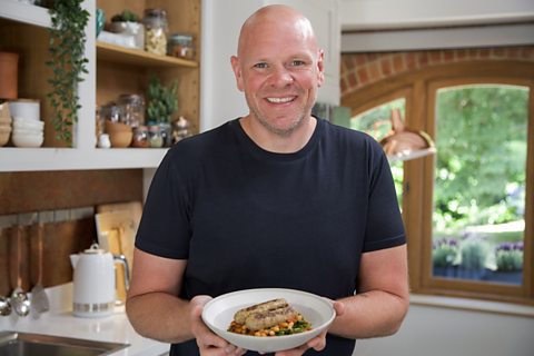 Tom Kerridge holding a dish he has prepared for the series Lose Weight And Get Fit with Tom Kerridge