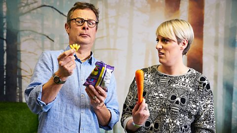 Hugh Fearnley-Whittingstall holds up a crisp looking appalled by it while Steph McGovern holds up a carrot looking shocked at Hugh