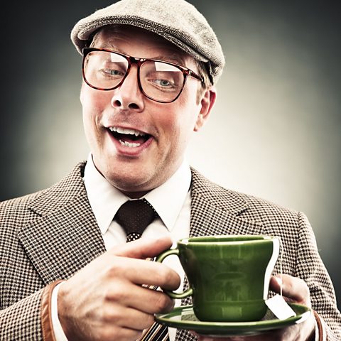 A man looking at a cup of tea.