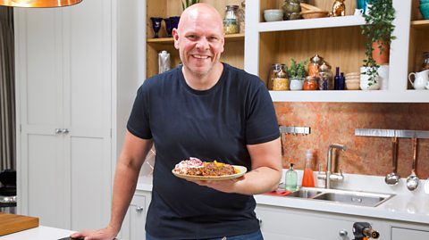 Tom Kerridge holding a plate of healthy food