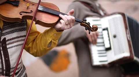 A fiddle player accompanied by an accordionist.