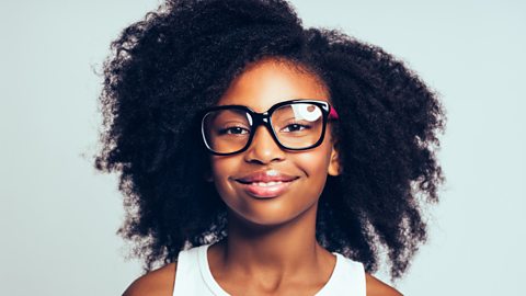 A photo of a young teenage girl wearing glasses