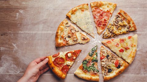 A photo of a pizza cut up into slices. Each slice has a different topping.