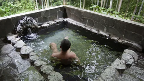 John S Lander/Getty Images Onsen, which source mineral-rich spring water heated by natural volcanic activity, are usually designed with beautiful outdoor views (Credit: John S Lander/Getty Images)