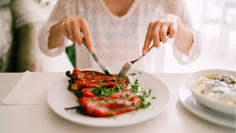 Getty Images Woman eating roasted peppers (Credit: Getty Images)