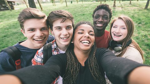 A photo of a group of teenagers taking a selfie