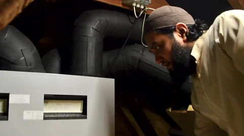 Laura Cole Saif Muhammad is taking part in a trial of a heating system designed to recycle warm rising air from inside houses back down to where it is useful (Credit: Laura Cole)