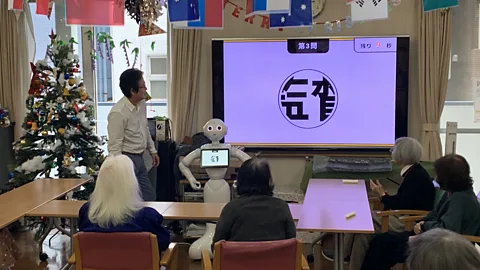 Bryan Lufkin Pepper, a robot created by tech giant Softbank first released in 2015, leads a game in a nursing home. Such robots still aren't commonplace, however (Credit: Bryan Lufkin)