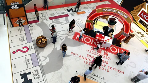 Getty Images Shoppers in China walk over a giant version of the game which celebrates its 80th anniversary (Credit: Getty Images)