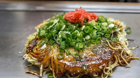 vichie81/Getty Images Okonomiyaki has been called “the Japanese pizza” or “the Japanese pancake” (Credit: vichie81/Getty Images)