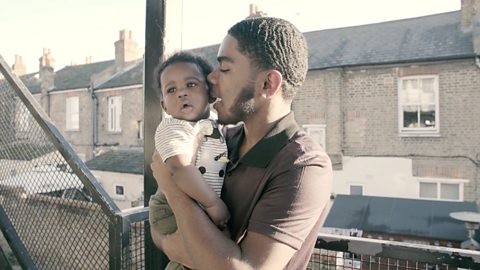 Dad holding toddler outside