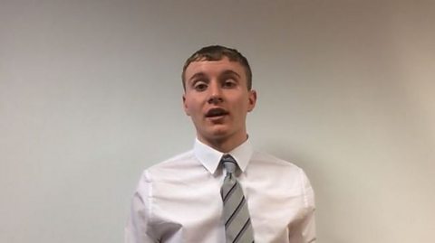 A screenshot of Scott, a 16-year-old white male from Glasgow. He is wearing a white shirt and a grey tie and is stood against a white background.