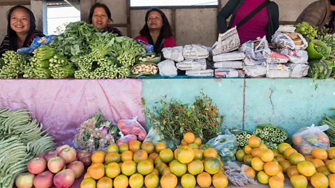Pearly Jacob Stalls sell mustard greens wrapped in banana leaves, young bamboo shoots and jaggery (Credit: Pearly Jacob)