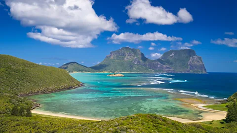 photosbyash/Getty Images Lord Howe Island hugs a turquoise lagoon rimmed with the world’s southernmost coral reef (Credit: photosbyash/Getty Images)