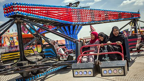 Muslim girls on a fairground ride at the Southwark Eid Festival in Burgess Park, London.