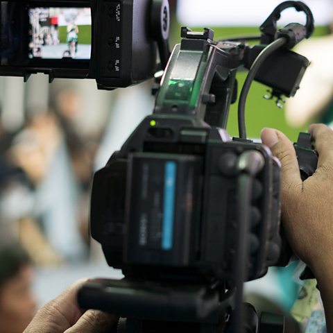 Close up of a camera filming. 