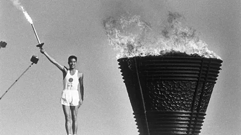 Alamy At the 1964 Tokyo Olympics, the Olympic flame - carried by Yoshinori Sakai - was a symbol of Japan's postwar reconstruction (credit: Alamy)