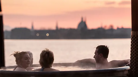 CopenHot Winter swimming enthusiasts say they experience a powerful endorphin rush when jumping into cold water after spending time in a sauna.(Credit: CopenHot)