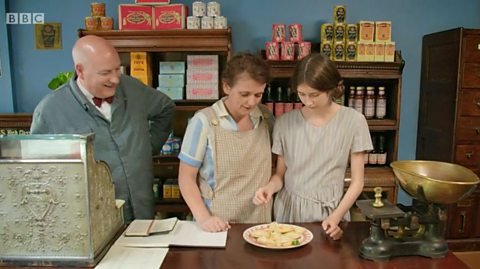 Dave, Jo and Olivia look over a plate of the pasties while standing in the shop