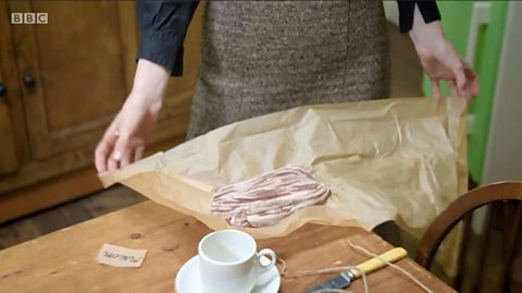 Strips of macon being opened up from its paper wrapping