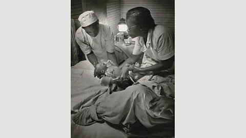 The Picture Collection Inc Midwife Maude Callen delivers a baby, Pineville, South Carolina, 1951 by W Eugene Smith (Credit: The Picture Collection Inc)