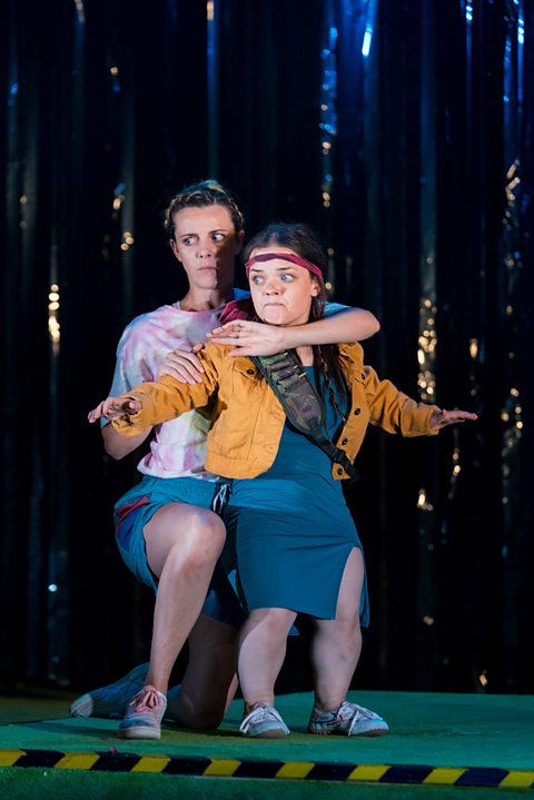 One actress holds another actress on stage in Pity