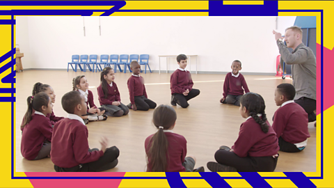 A group of school children sat in a circle taught by Andy Smith