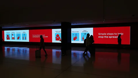 Getty Images Warnings greet travellers at Sydney International Airport. From Wednesday 25 March, all international travel to Australia was banned (Credit: Getty Images)