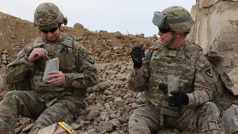 David Kamm, U.S Army CCDC Soldier Center Two US soldiers tuck into their MREs (Credit: David Kamm, U.S Army CCDC Soldier Center)