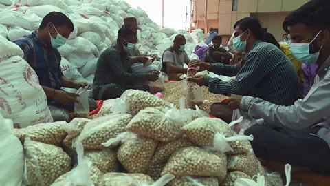 Asif Hassan/Getty Images Amid the pandemic, many Pakistanis are offering a Muslim charity tax called "zakat" to help those eat who can no longer work (Credit: Asif Hassan/Getty Images)
