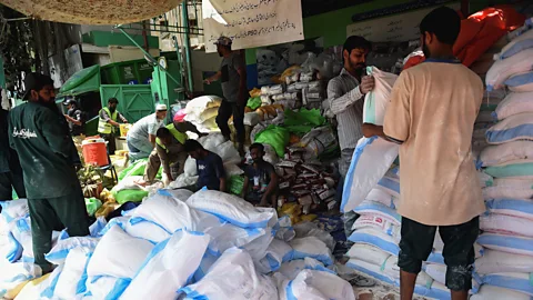 Rizwan Tabassum/Getty Images Many zakat donations go towards creating monthly ration packets that provide daily wage earners basic grocery items (Credit: Rizwan Tabassum/Getty Images)