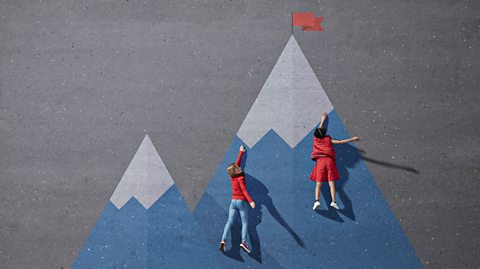 Young people climbing a mountain drawn on ground