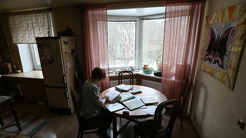 Getty Images Veronika Makarova reads fairy tales to children on the phone, working from her apartment during the Covid-19 pandemic (Credit: Getty Images)