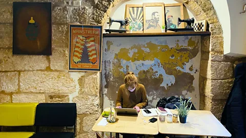 Political artwork decks the walls at The Singer Cafe, a crossroads of artists, activists and tourists (Richard Morgan)